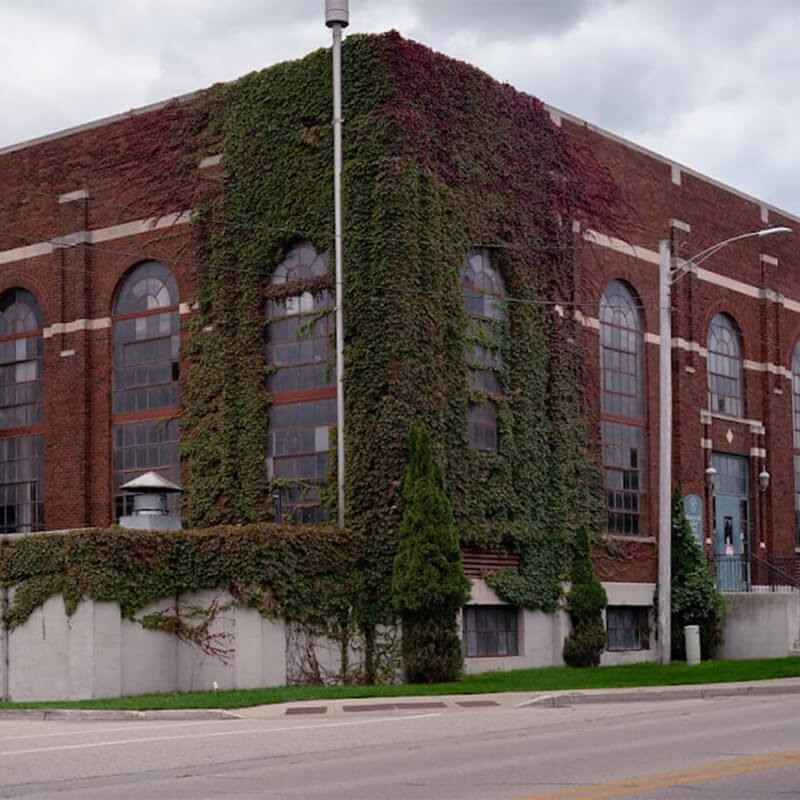 Exterior corner of brick grand haven power plant with ivy growing along the outside