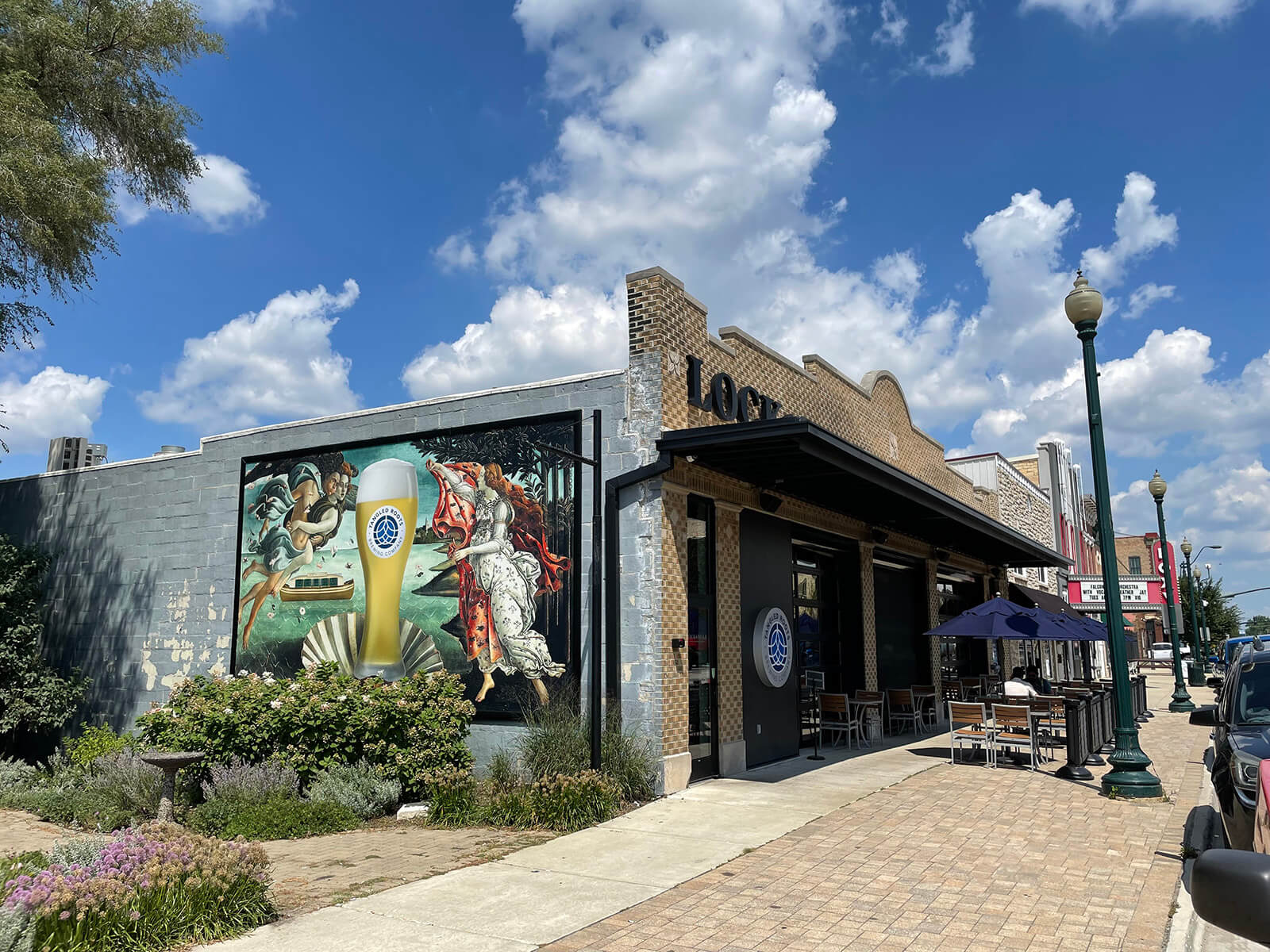 Completed Tangled Roots Brewing mural on side of Lock and Mule building