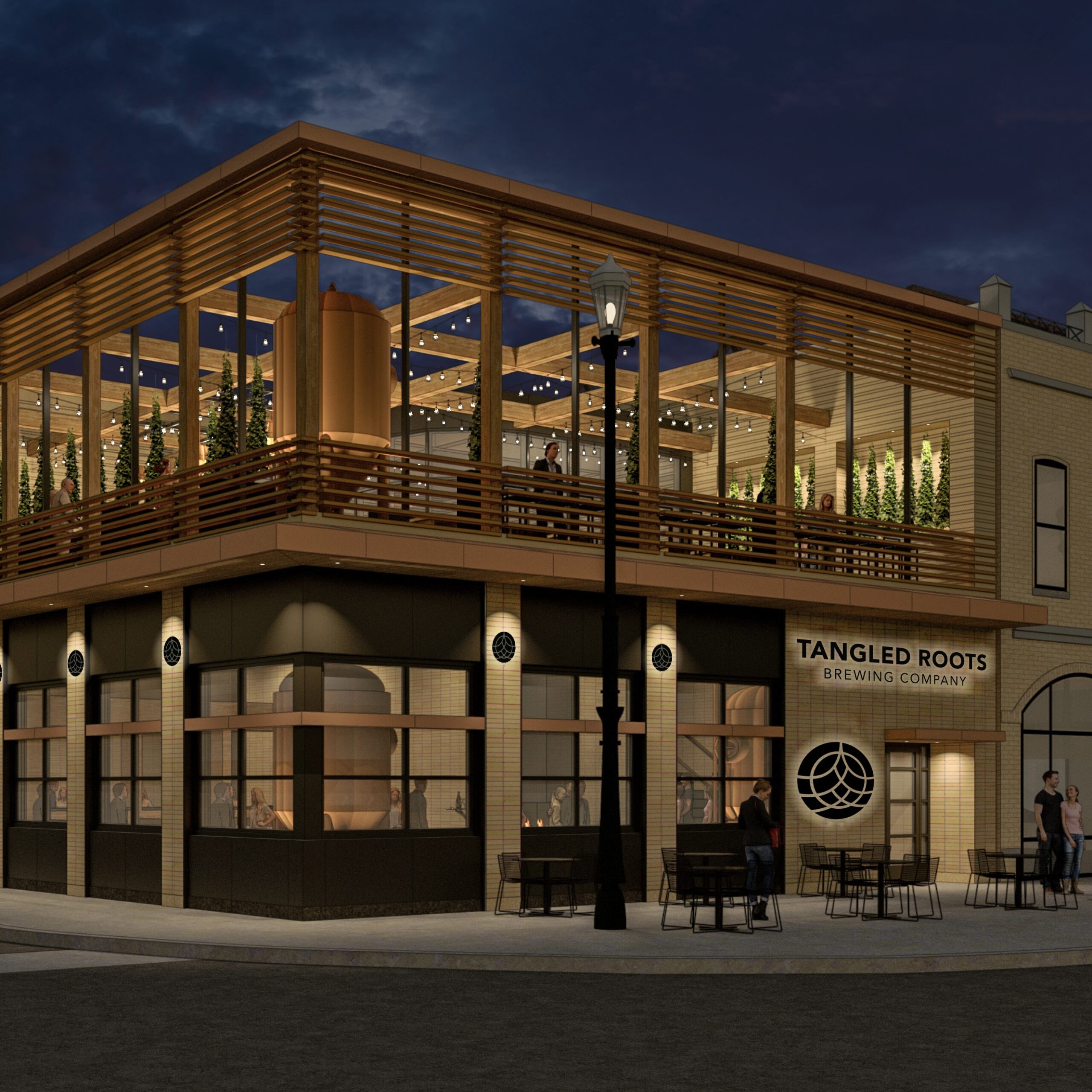 The exterior of a two story brick brew pub with outdoor dining in a beer garden on the second floor.