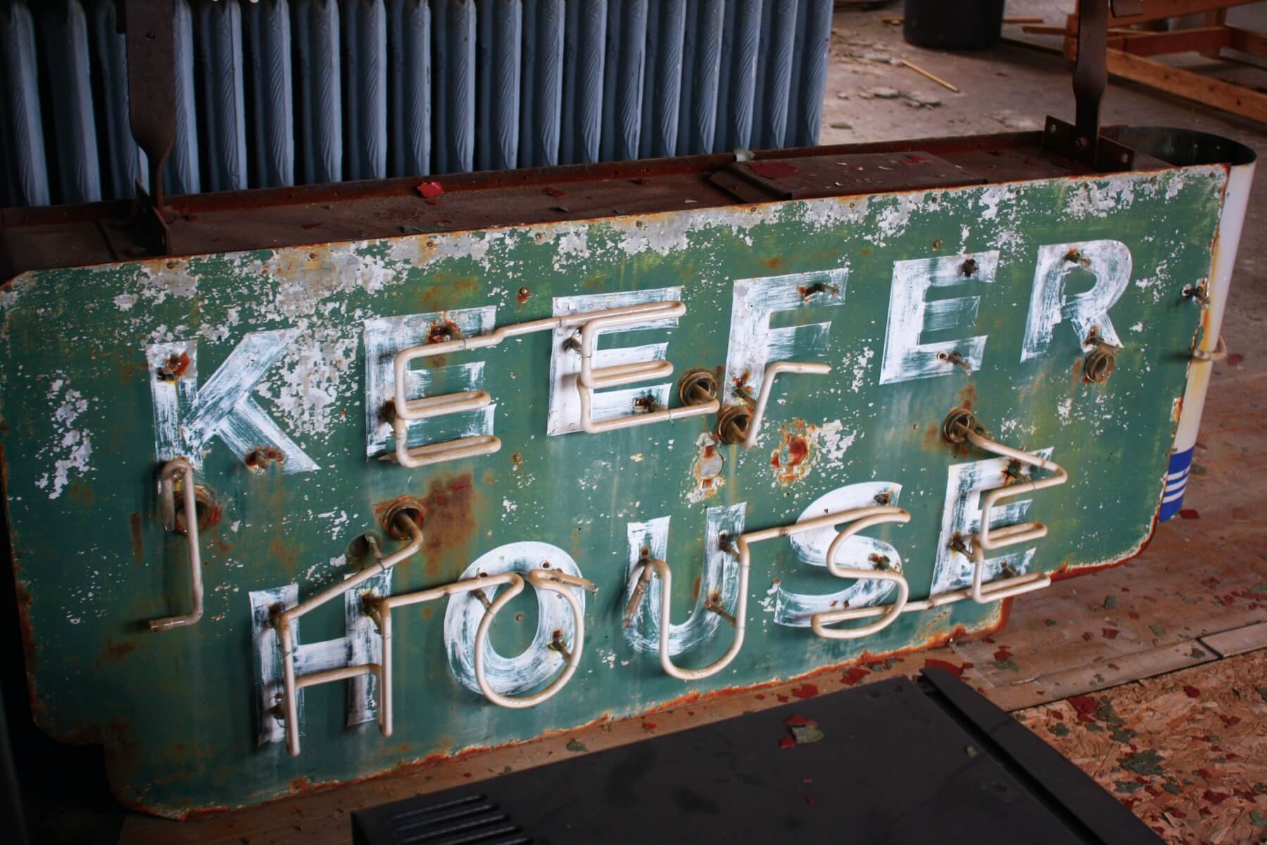 old rusty neon sign for the keefer house hotel