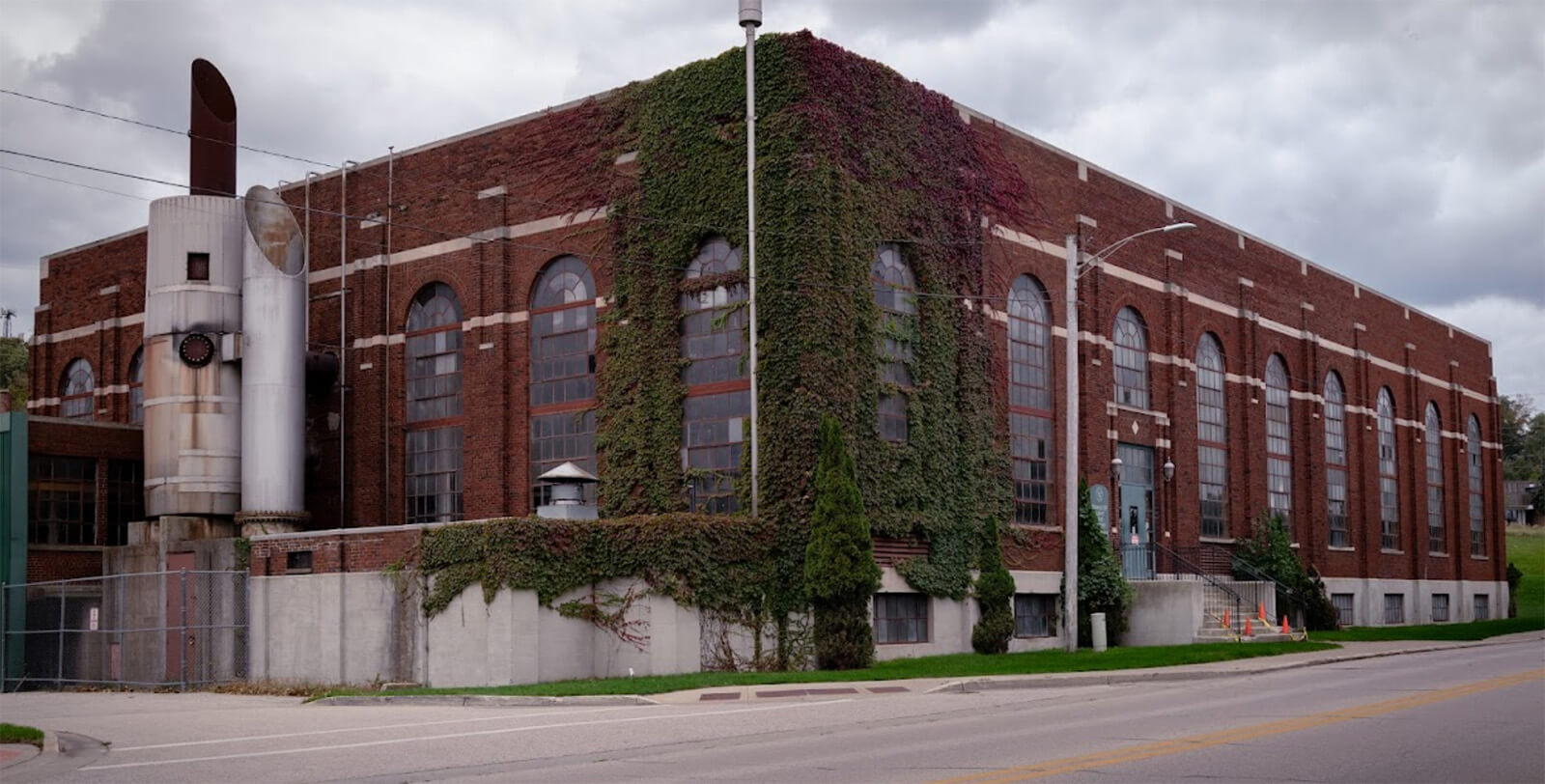 Exterior corner of brick grand haven power plant with ivy growing along the outside